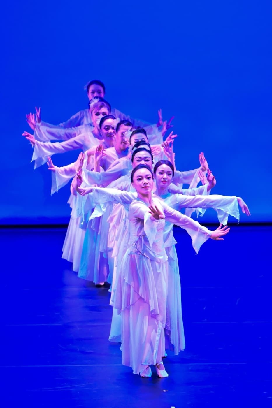 Dancers lined up respectfully in a studio